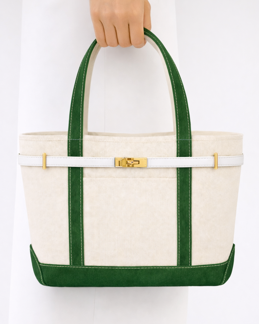 White tote bag with green straps held by a hand on a white background in Masters Golf Green Golf Augusta National 